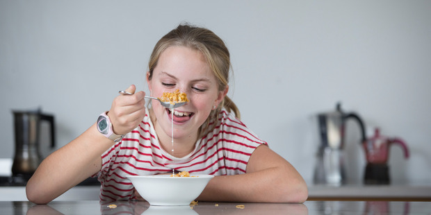 Yasmin Robertson, 10, samples Kellogg's Frosties at her family home. Photo / Greg Bowker
