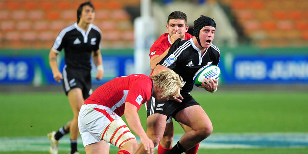 Nick Ross of New Zealand is tackled by Luke Hamilton of Wales. IRB Junior World Championship 2012. Photo / BackpagePix