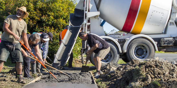 Reuben Taipari, who provided the concreting tools and expertise, Moana Erickson (OTC), Percy Fepuluai (Bonnetts Road resident) and Jason Reti, who was the driving force behind the project, at work.
