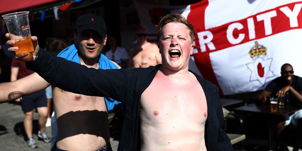 England fans chant as they drink in a bar ahead of the England v Russia game. Photo / Getty Images.
