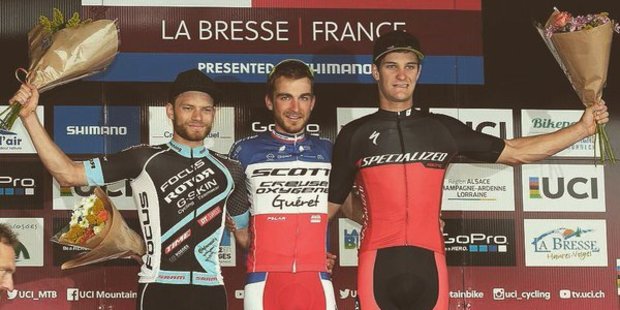 Sam Gaze (far right) on the podium after finishing third in the men's under 23 section of the UCI Mountain Biking World Cup in France last month. Photo / Twitter