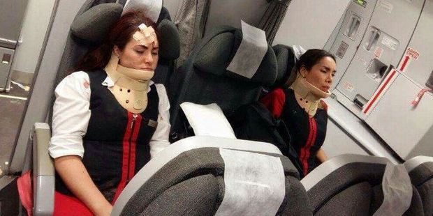 This image of two flight attendants sitting at the back of their aircraft in neck braces was uploaded to Twitter shortly after the flight. Photo / TrafficAirColom Twitter