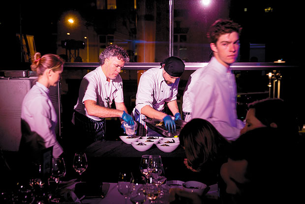 Peter Gordon and team plate "Black Splash", which guests ate while wearing waterproof bibs. Photo / Dean Purcell