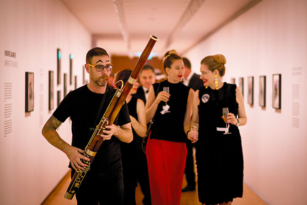 Ben Hoadley on bassoon leads guests, including gallery director Rhana Devenport (right) to dinner. Photo / Dean Purcell