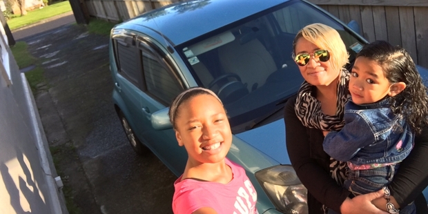 Brenda Sekona with daughters Cherlese, 11, and Caroline, 3, and their new car.