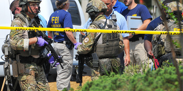 FBI, Orlando Police Department and the Orange County Sheriff's Office personnel investigate the attack at the Pulse nightclub. Photo / AP
