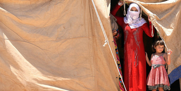 Internally displaced Iraqis at a camp outside Fallujah, Iraq. The UN estimates about 50,000 civilians are trapped inside the city and that 42,000 people have fled recently. AP photo / Hadi Mizban