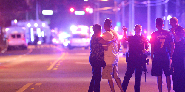 Orlando Police officers direct family members away from the Pulse Orlando nightclub. Photo / AP