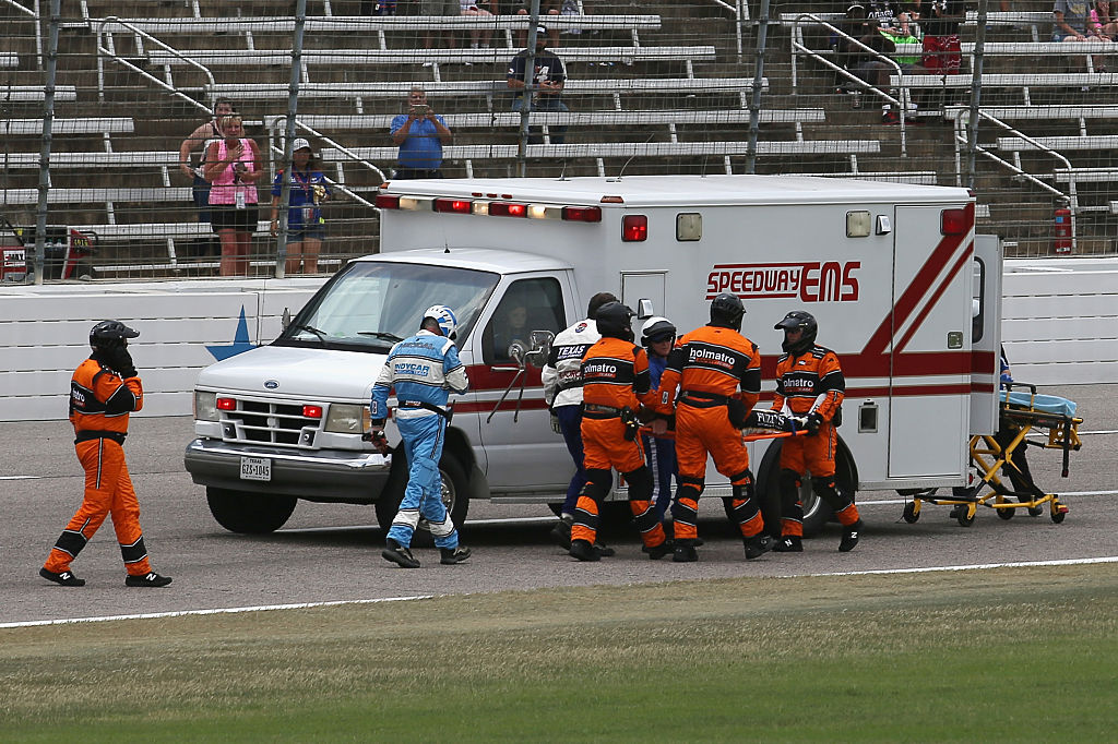 Josef Newgarden is carried off of the track by emergency officials. Photo / Getty
