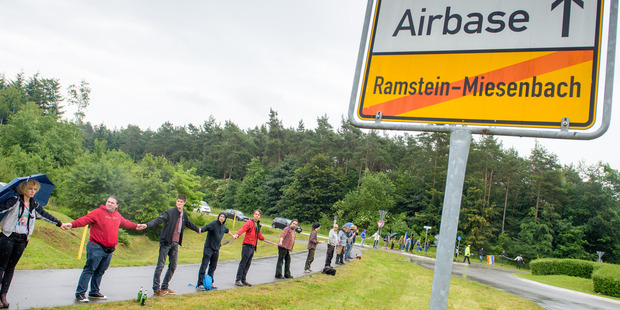 Peace activists form a human chain on the street leading towards the US air base during the 'Stopp-Ramstein' campaign in Ramstein, Germany. Photo / AP