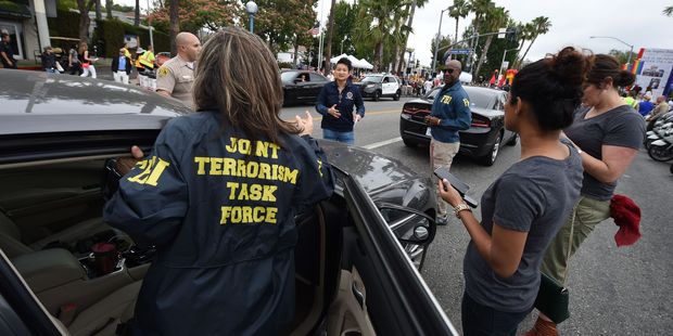 Members of the FBI Joint Terrorism task force stand by to provide security for the 2016 Gay Pride Parade June 12, 20116 in Los Angeles. Photo / Getty