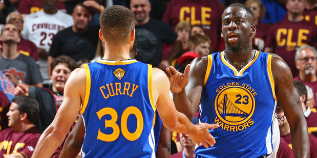 Steph Curry (left) shakes hands with Draymond Green during an NBA Finals match against the Cleveland Cavaliers. Photo / Getty Images