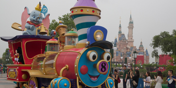 A train parade float passes by at the opening of Shanghai Disneyland. Photo / AP