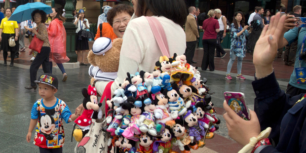 Visitors wear Mickey and Minnie Mouse memorabilia at Shanghai Disneyland. Photo / AP