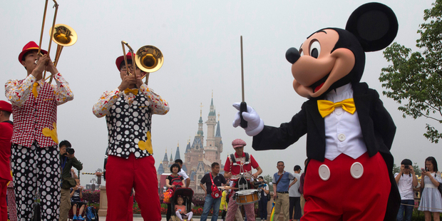 Mickey Mouse entertains visitors on the opening day of Shanghai Disneyland. Photo / AP