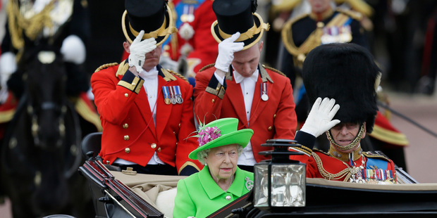 Queen Elizabeth II and Prince Philip ride in a carriage during the Trooping The Colour parade at Buckingham Palace. Photo / AP
