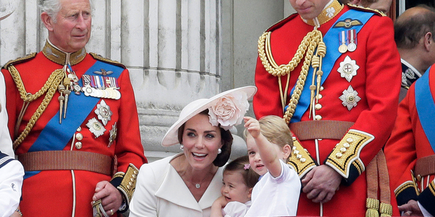 Prince William, Prince George and Kate holding Princess Charlotte, centre, with The Prince of Wales, left, on the balcony during the Trooping The Colour parade at Buckingham Palace. Photo / AP