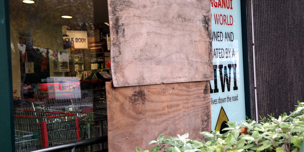 BOARDED UP: A burglar got in and out of Whanganui's New World supermarket through a hole broken in this window.