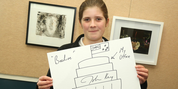 Turakina student Isabella Ford, 12, with the Prime Minister's contribution to the art auction. Photo/Bevan Conley
