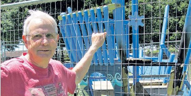 The pirate ship after it was damaged in the arson attack. Pictured with it before it was removed was Lions Club member Ray Hilliker, a co-ordinator of the park.