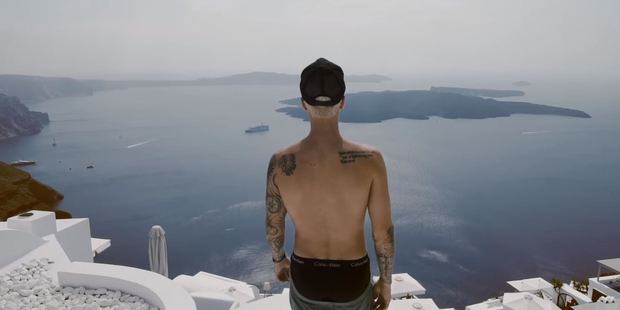 Justin Bieber looks out over the Greek island of Santorini in his new video for Company. Photo / YouTube