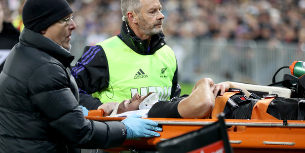 Aaron Cruden leaves the field suffering a neck injury. Photo / Getty