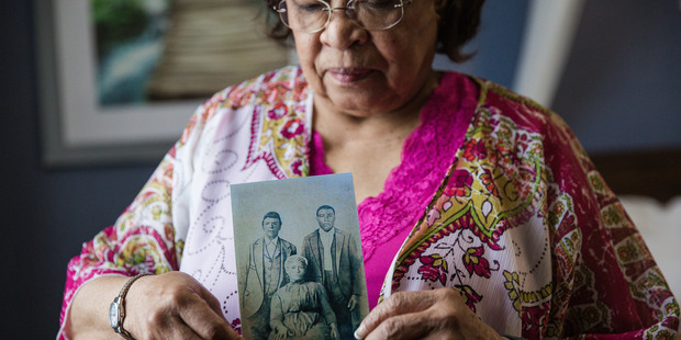 Patricia Bayonne-Johnson holds a photo of her great grandparents and their son. Photo / Nick Otto, Washington Post