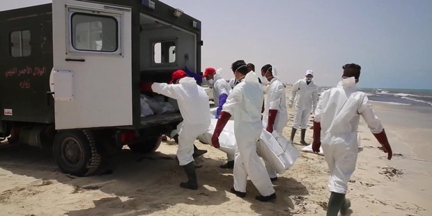 It is often left to emergency services, this time in Libya, to remove the bodies of victims that swash up on the shore after a boat crammed with migrants sinks in the Mediterranean. Photo / AP