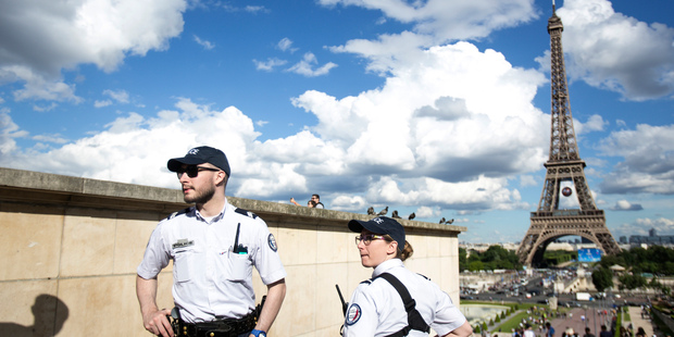 French police officers patrol at Trocadero Plaza next to the Eiffel Tower in Paris. Photo / AP