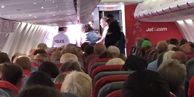 Kyle Falconer of The View was photographed being escorted off the plane. Photo / Richard Davidson