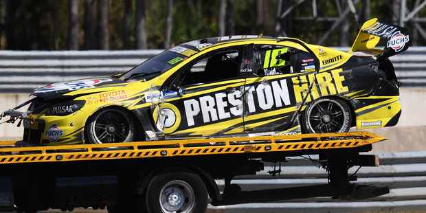 The car of Lee Holdsworth is towed off the track after crashing. Photo / Getty Images
