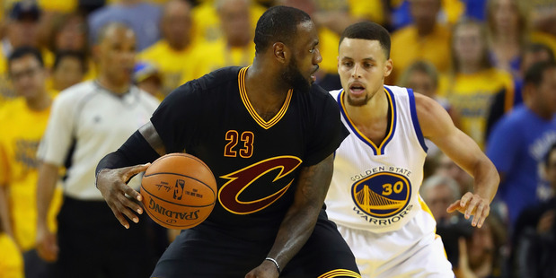 LeBron James handles the ball against Stephen Curry in Game 7. Photo / Getty Images