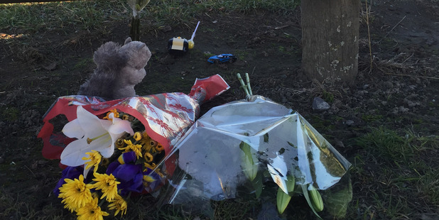 Flowers and toys at the Cowles Stadium carpark in Christchurch, where a two-year-old boy was killed. Photo / Kurt Bayer