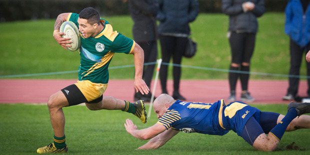 Mount Maunganui Sports fullback Isaac Te Aute beats Steve Honey to score his third try in the trouncing of Tauranga Sports on Saturday. Photo / Andrew Warner