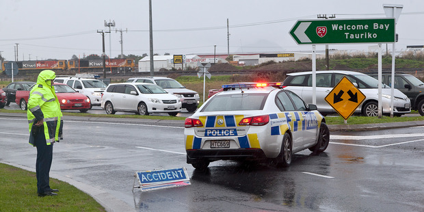 Police at the scene of the road block near Maungatapu Bridge. Photo / Andrew Warner