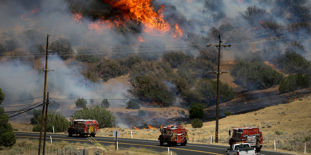 Fire trucks move along Highway 178 near Lake Isabella, California. Photo / AP