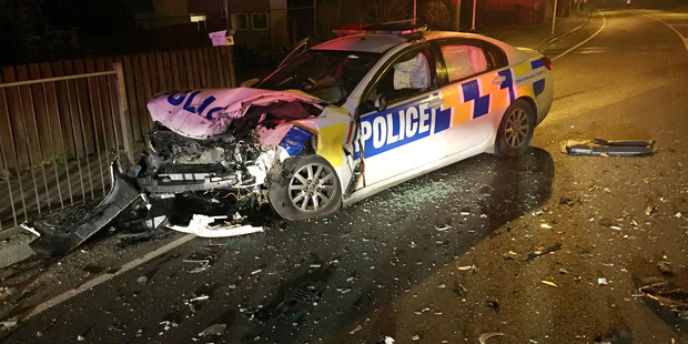 Two policemen suffered minor injuries after a collision with a fleeing vehicle on State Highway 1 near Otaika Shopping Centre.
