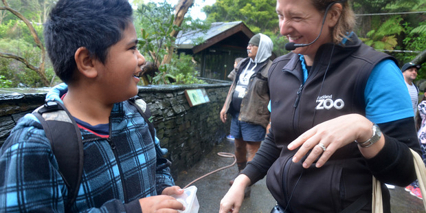First Zoofari adventure for Kaitaia's animal loving students. Rangipo Matiu from Oturu School enjoys time with Auckland Zoo educator Sarah Skoggard in the Zoo's High Country aviary.