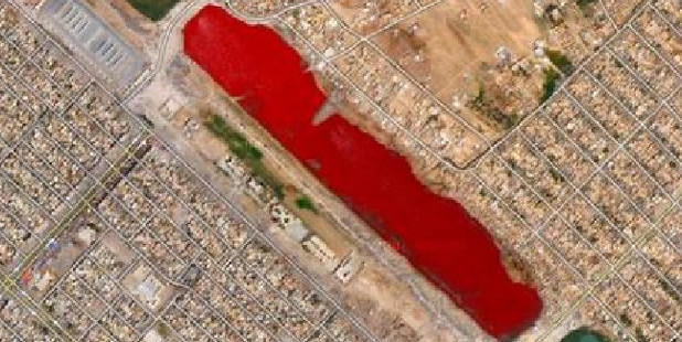 This blood-red lake outside Sadr City left many speculating what it could be from. Image / Google