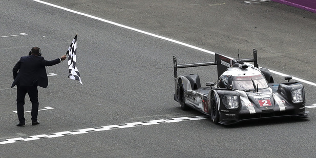 The Porsche 919 Hybrid No2 of the Porsche Team crosses the finish line to win the 84th 24-hour Le Mans endurance race. Photo / AP