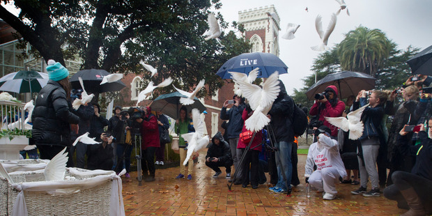 Doves are released outside Auckland High Court to mark the victims of child abuse. Photo / Nick Reed