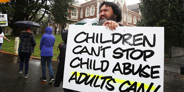 Togia Lanefale joins the protest outside Auckland High Court. Photo / Getty Images