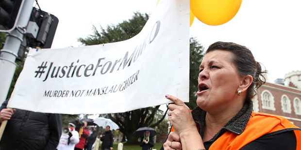 Jeanine Perkinson leads the chant outside Auckland High Court. Photo / Getty Images