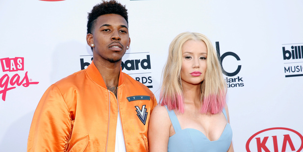 Iggy Azalea with her ex Nick Young at the Billboard Music Awards. Azalea says she caught Young cheating on home video footage. Photo/AP