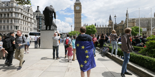 A demonstrator wrapped in the EU flag takes part in a protest opposing Britain's exit from the European Union in London at the weekend. Photo / AP