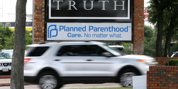 Traffic passes a Planned Parenthood sign in Dallas. The Supreme Court struck down Texas' widely replicated regulation of abortion clinics. Photo / AP