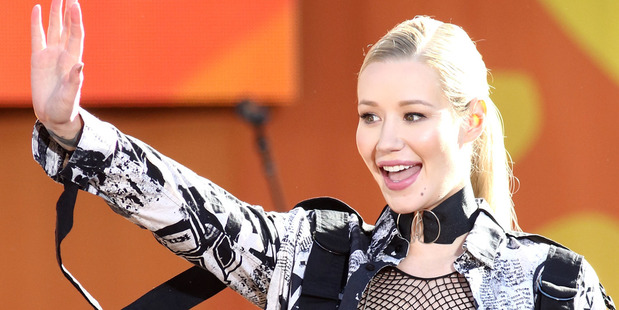 Singer Iggy Azalea says she left her fiancé Nick Young after catching him cheating on home security camera footage. Photo/AP