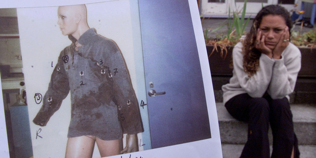 Kelly Wallace, Steven Wallace's sister, with a picture of Wallace's bloodstained shirt in the foreground. Photo / Supplied