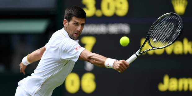 Novak Djokovic plays a backhand during the first round of Wimbledon. Photo / Getty Images