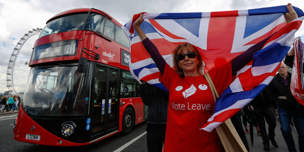 A campaigner wearing a Vote Leave t-shirt and holding a British Union Flag. Photo / Luke MacGregor/Bloomberg